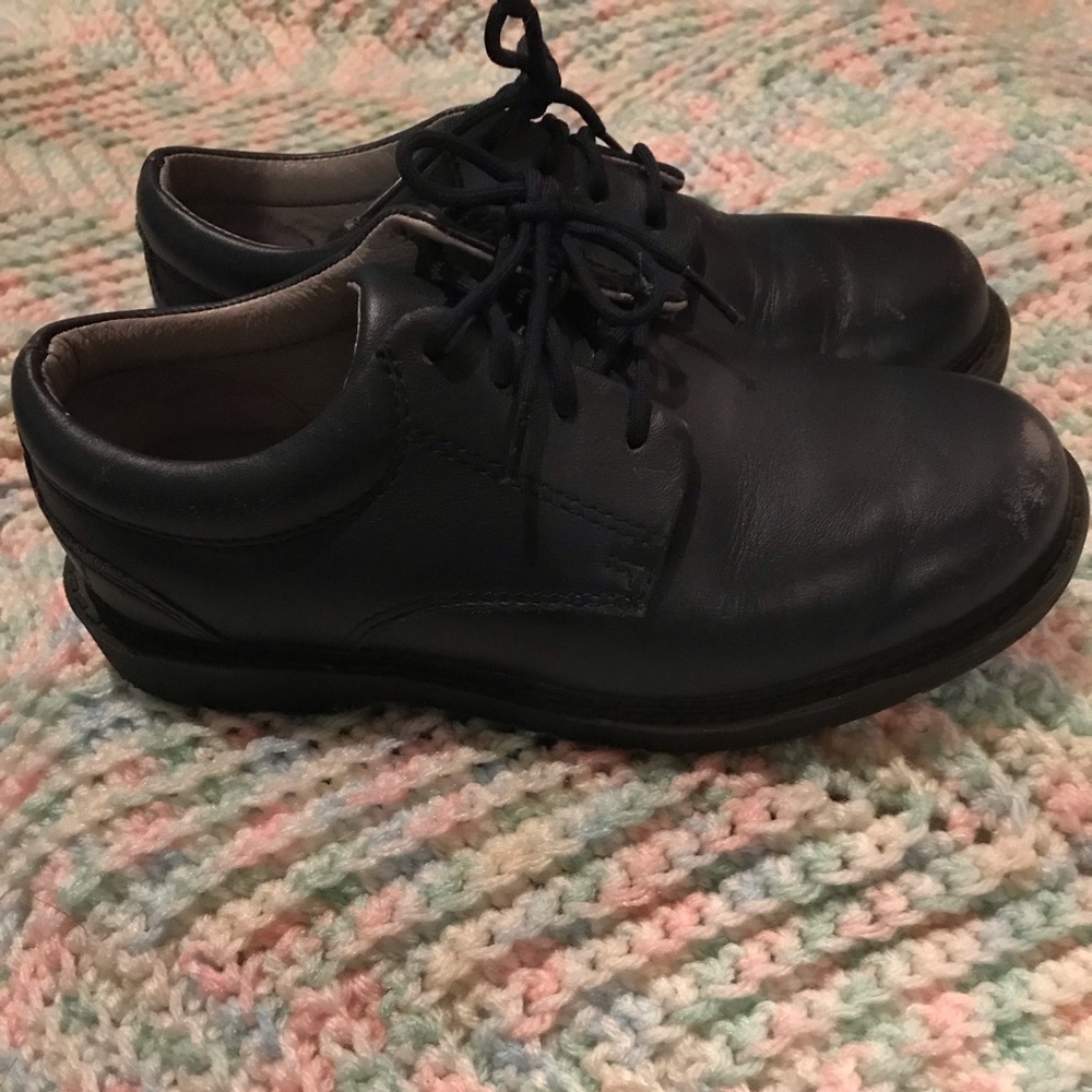 Navy blue school oxfords, in need of a polishing.